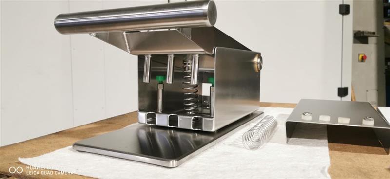 Edelstahlmaschine mit Schneidwerkzeugen und Steuerungspanel auf Arbeitstisch, Klumpp Wasserstrahlschneiden Technologie.